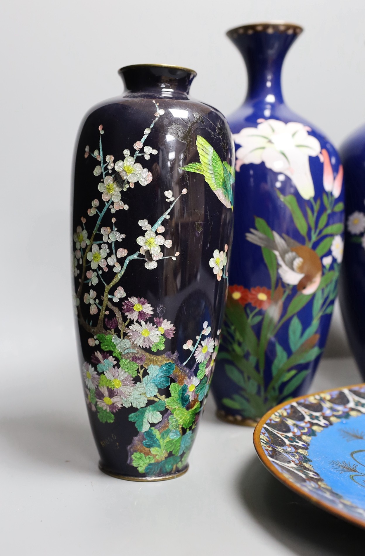 A group of Japanese cloisonné enamel wares to include a pair of vases, two other vases and a dish, Meiji period